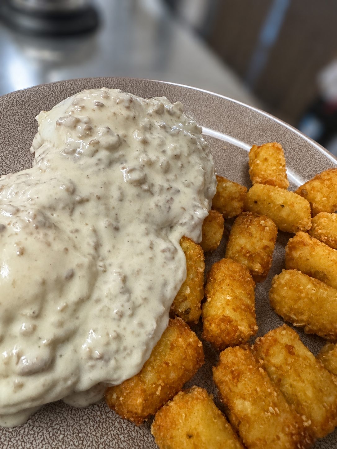 The country benedict, sausage gravy over biscuits and eggs