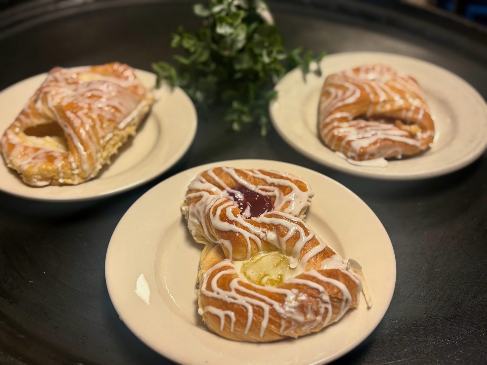 Fresh glazed danishes on diner plates