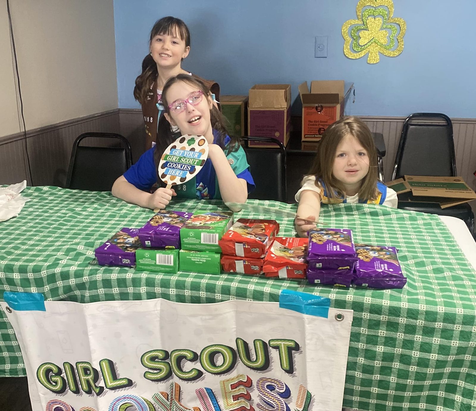 Girl Scouts selling cookies at their table at the diner